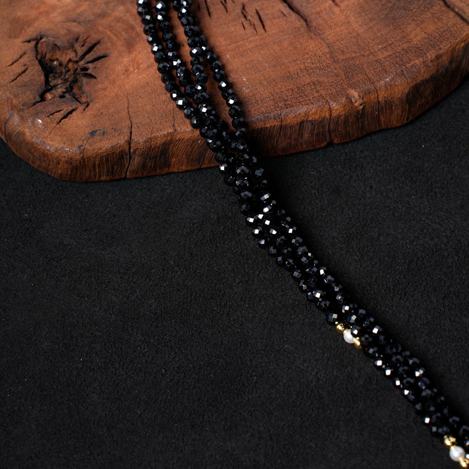 Detailed close-up of the multiple strands of faceted black spinel beads interspersed with delicate white pearls in Nuwa Stone's "Ink Begonia Cascading Snow" necklace, showcasing the fine beadwork and contrast.